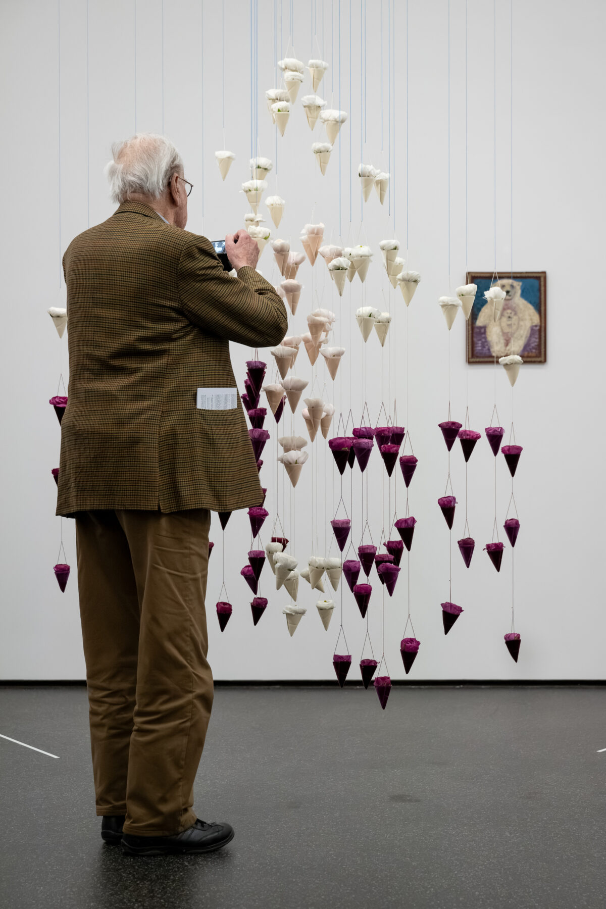 Foto von Personen, die vor einer Blumen für die Kunst Installation stehen